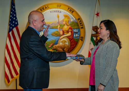 Stoyan Bumbalov is sworn in by Department of General Services Director Ana Lasso