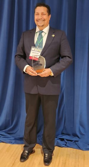 Enrique holding his award trophy