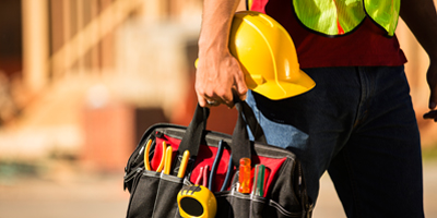 Displays a construction worker with a tool belt